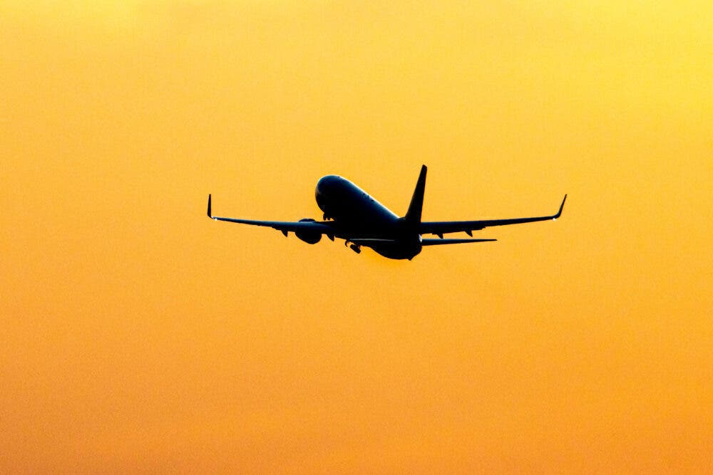 Silhouette Of A Departing Aircraft During Sunset